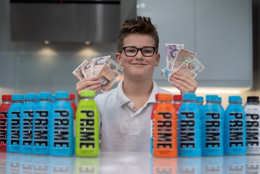 Boy selling empty Prime energy drink bottles