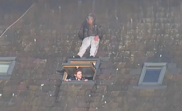 Man trying to avoid police pictured hiding on roof