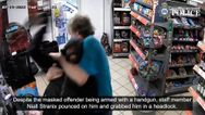 Moment Mop-wielding have-a-go-hero puts armed robber in headlock
