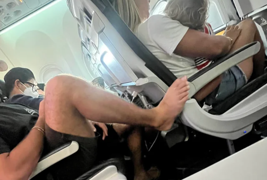 Plane passenger sparks outrage after putting his bare foot on armrest in front