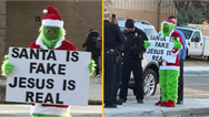 Grinch stands outside primary school with ‘Santa is fake’ sign