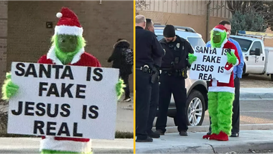 Grinch stands outside primary school with ‘Santa is fake’ sign